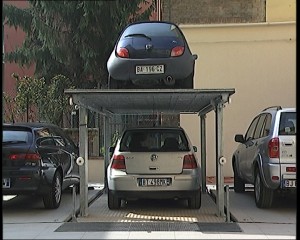 Sistema di parcheggio per autoveicoli a comando elettrico con movimentazioni oleodinamiche con due piattaforme per il parcheggio di un’auto sotto il livello cortile e la seconda a livello cortile/giardino; permette il parcheggio di due autovetture in maniera indipendente oppure di una autovettura a scomparsa sia all’interno che all’esterno